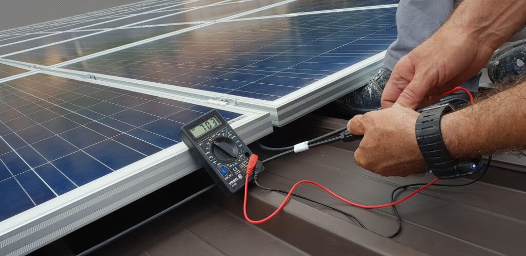 Solar System Upgrades and Repairs Tecnician with Testing Meter - Upgrades and Repairs - Solar System Upgrades and Repairs